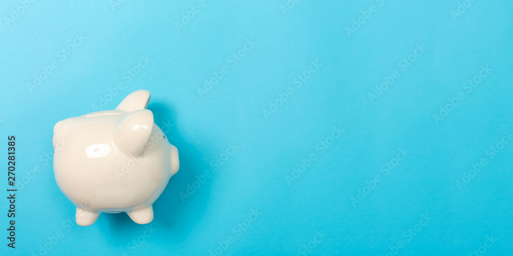 A piggy bank saving and investment theme on a blue paper background A piggy bank saving and investment theme on a blue paper background