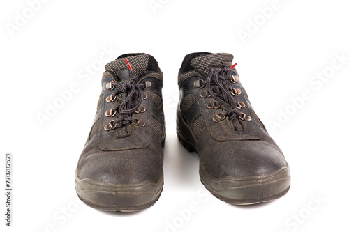 a pair of used blue leather work shoes with fabric incuts isolated on white background photo