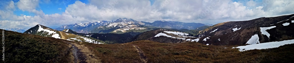 Panoramic mountains landscape in early spring - snow in the mountains 