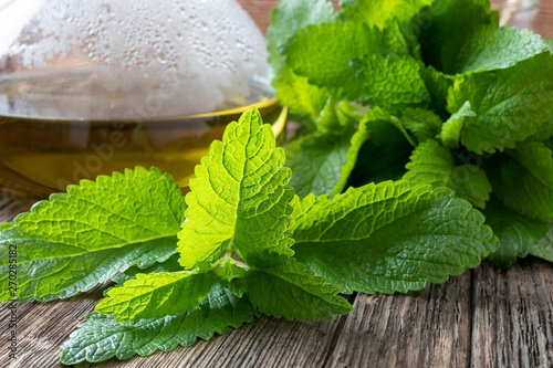 Fresh melissa leaves and tea on a table