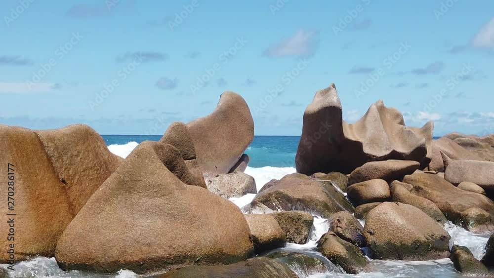 SLOW MOTION: Swimming pool Anse Marrone, La Digue. Happy woman in bikini lying on turquoise water of natural pool at Anse Marron by rock formations. Scenic landscape of secret beach at Seychelles. SLOW MOTION: Swimming pool Anse Marrone, La Digue. Happy woman in bikini lying on turquoise water of natural pool at Anse Marron by rock formations. Scenic landscape of secret beach at Seychelles.