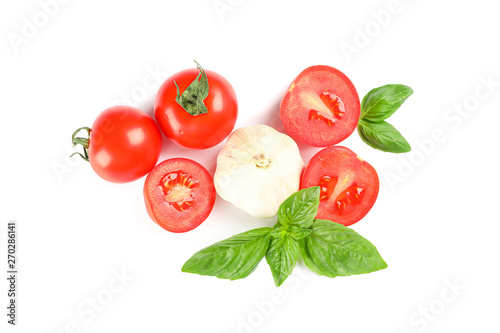 Fresh cherry tomatoes with basil and garlic isolated on white background, top view. Ripe vegetables