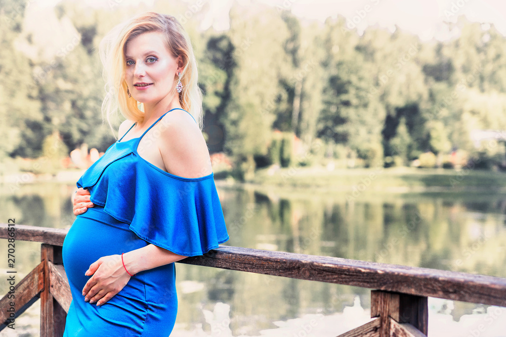 pregnant beautiful woman posing in the park