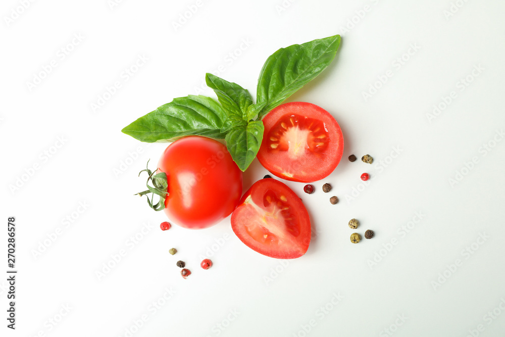 Fresh cherry tomatoes with basil and spices on white background, space for text and top view. Ripe vegetables Fresh cherry tomatoes with basil and spices on white background, space for text and top view. Ripe vegetables