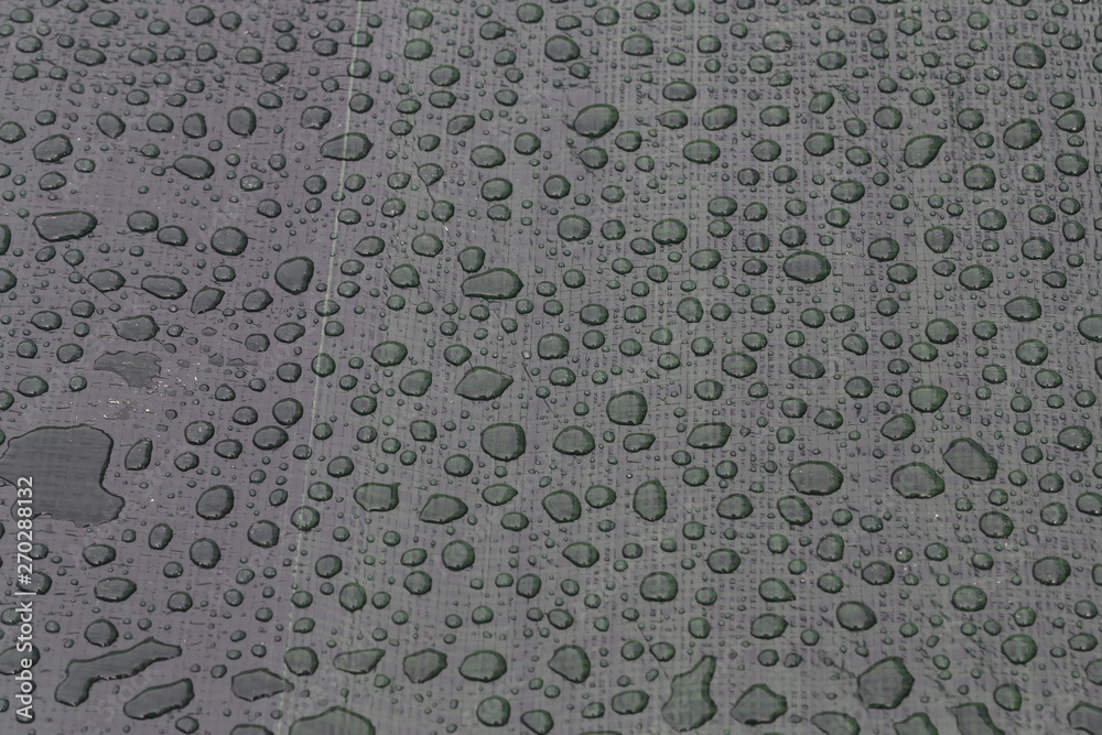 Large drops of water on plastic film after rain Large drops of water on plastic film after rain