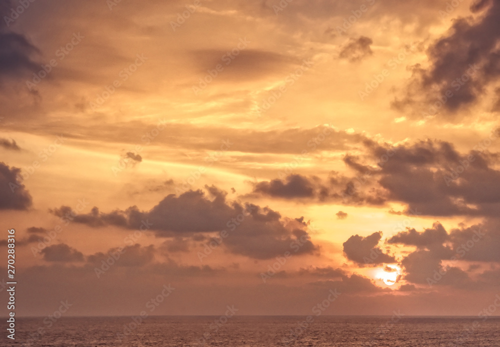 Scenic sky sunset with sun sea horizon with clouds orange background 