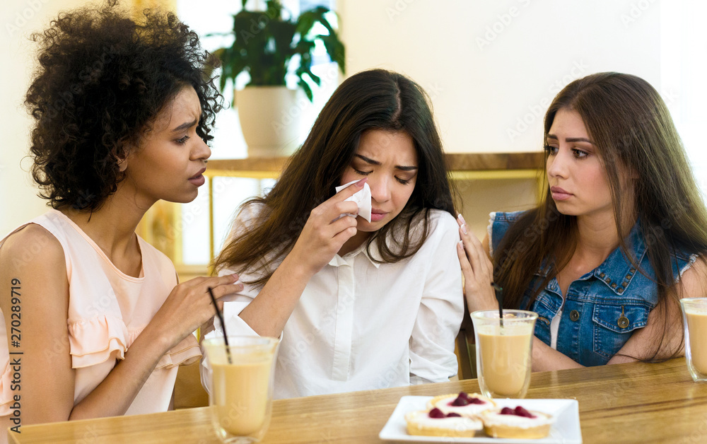 Two friends cheering up young depressed girl Two friends cheering up young depressed girl