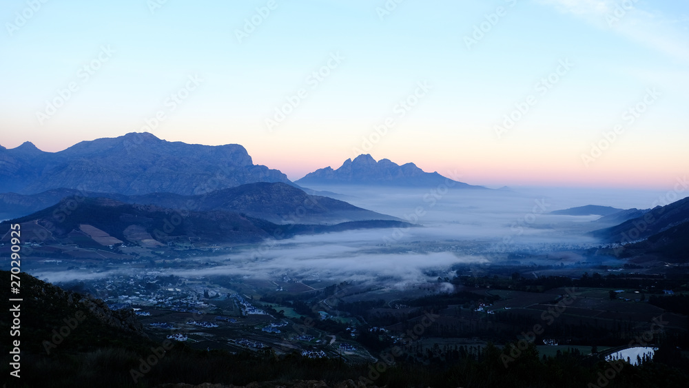 Early morning view of sunrise over Franschhoek town, South Africa with mist