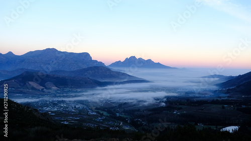Early morning view of sunrise over Franschhoek town, South Africa with mist