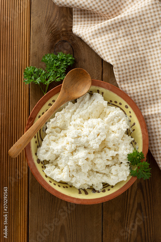 Cottage cheese isoalted on wooden background. Dairy products, calcium and protein. Healthy breakfast.