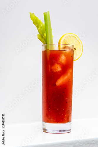 freshly made Bloody Mary cocktail or tomato juice, garnished with celery and lemon