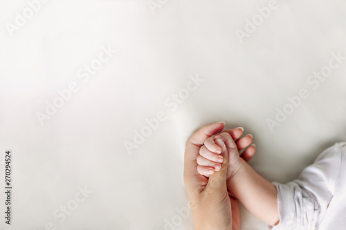 Hands of mother and baby closeup with copy space