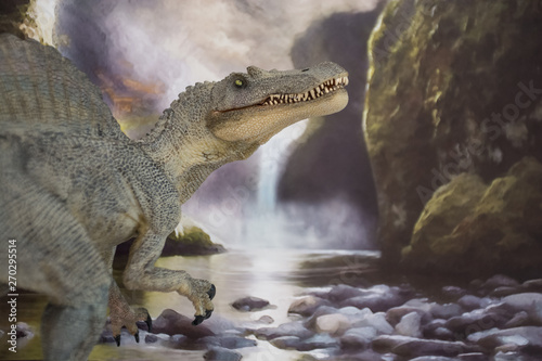 Spinosaur close to a waterfall where it can find animals and fishes to eat photo