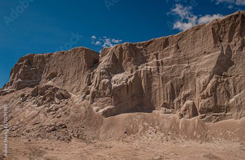A big pile of fine grain sand creating a cliffside.