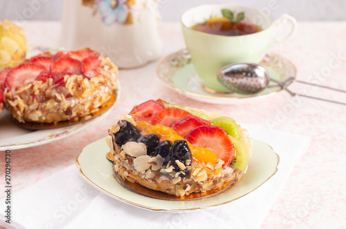 French Fruit Pastry on a China Plate on a Table Set for Tea