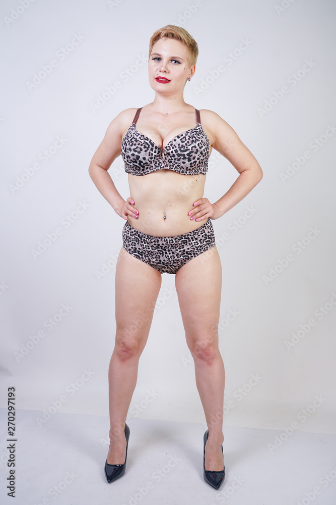 Beautiful young caucasian chubby woman with plus size body and pale skin  wearing sexy lingerie with leopard print on white studio background alone  Stock Photo | Adobe Stock