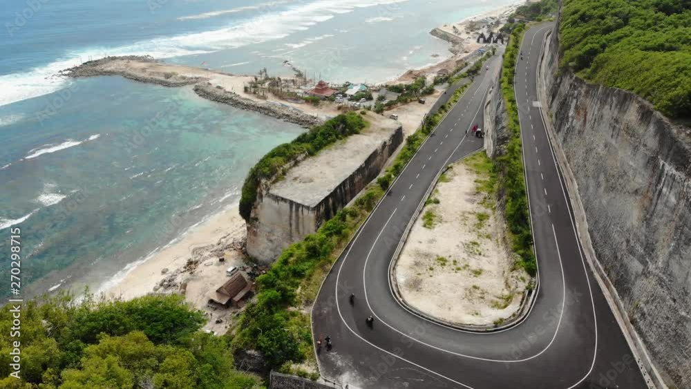 AERIAL: drone top view cars driving along the coastal road in mountains. Transportation in asia Bali, Hawaii AERIAL: drone top view cars driving along the coastal road in mountains. Transportation in asia Bali, Hawaii