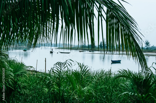 Scenic landscape  seen through palm leaves of Thu Bon River in Hoi An  Vietnam