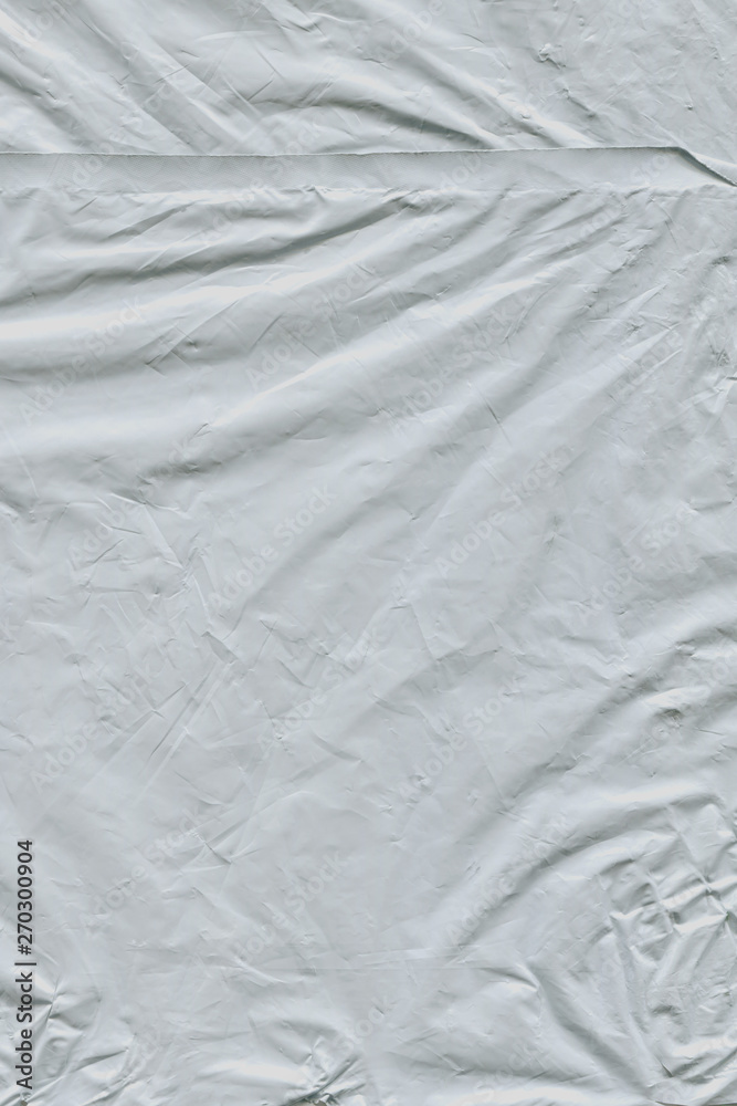 Naklejka premium Transparent plastic wrap on the black background. Plastic bag texture. Reusable trash and waste.