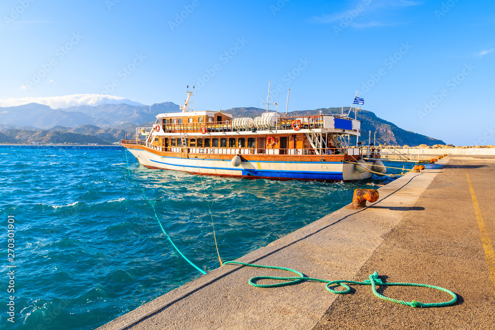 Tourist boat in picturesque Pigadia port, Karpathos island, Greece