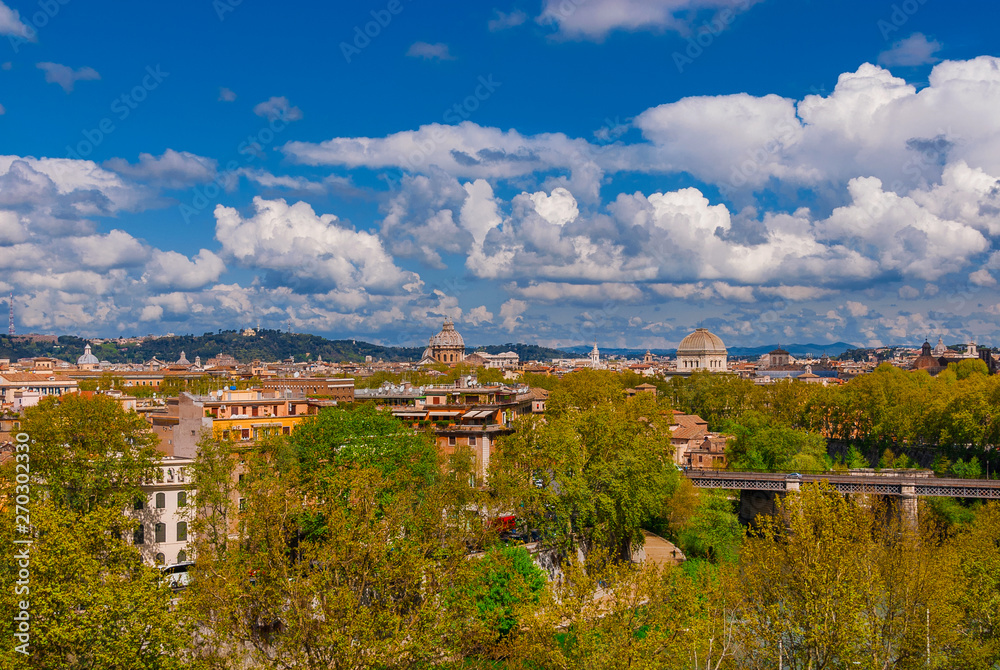 Rome historic center old skyline above Trastevere with old churches, belltowers, domes and clouds, seen from Aventine Hill