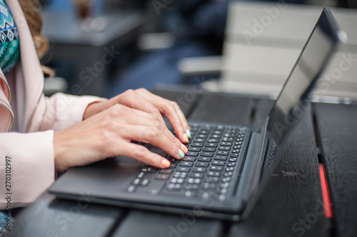 Close up of woman hand, blogger freelancer with computer laptop
