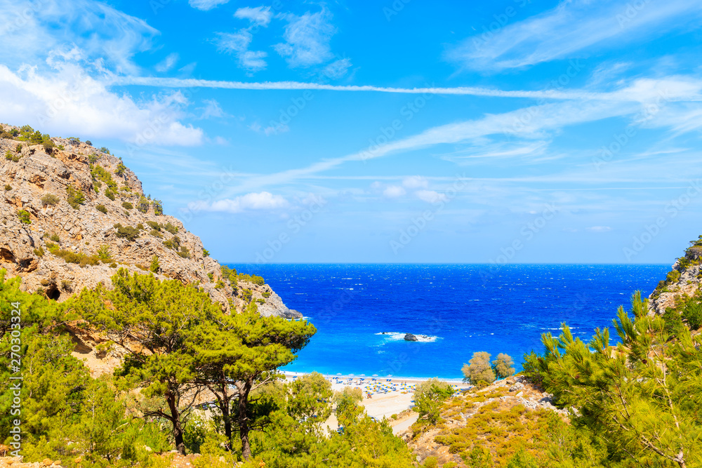 Achata bay with blue sea and green pine tree hills, Karpathos island, Greece