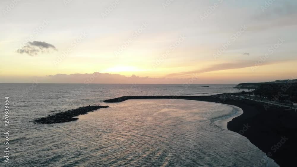 Aerial view of a beautiful sunset on the coast of an island in the Atlantic Ocean. Adeje, Tenerife island, Spain Aerial view of a beautiful sunset on the coast of an island in the Atlantic Ocean. Adeje, Tenerife island, Spain