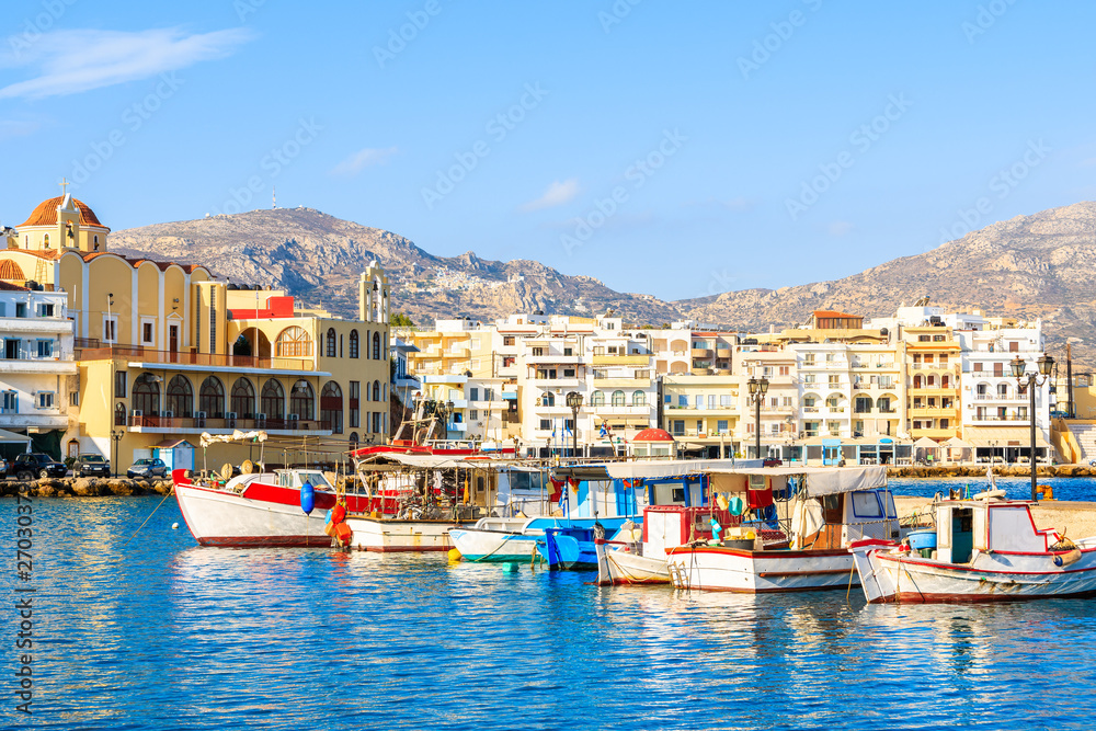Boats in beautiful Pigadia fishing port with mountains in background, Karpathos island, Greece