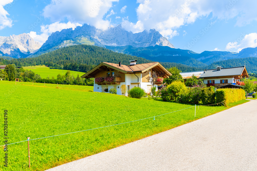 Traditional alpine houses in village of Going am Wilden Kaiser on beautiful sunny summer day, Tirol, Austria Traditional alpine houses in village of Going am Wilden Kaiser on beautiful sunny summer day, Tirol, Austria