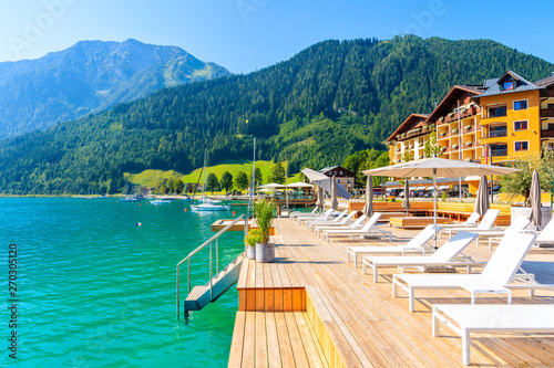 Obraz na płótnie Pier with chairs on sunny terrace on shore of beautiful Achensee lake on sunny summer day with blue sky, Karwendel mountain range, Tirol, Austria w salonie