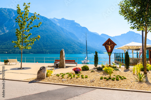 Coastal promenade with flowers at Achensee lake on sunny summer day, Tirol. During summer this place is very popular among tourists.