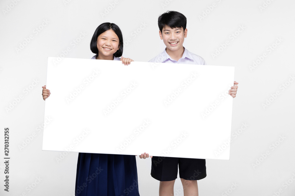 Cute Asian kids in student's uniform with white board. Cute Asian kids in student's uniform with white board.