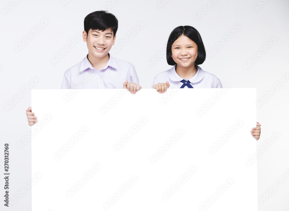 Cute Asian kids in student's uniform with white board. Cute Asian kids in student's uniform with white board.
