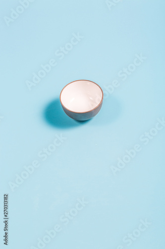 Crossing traditional small teacups on a blue background