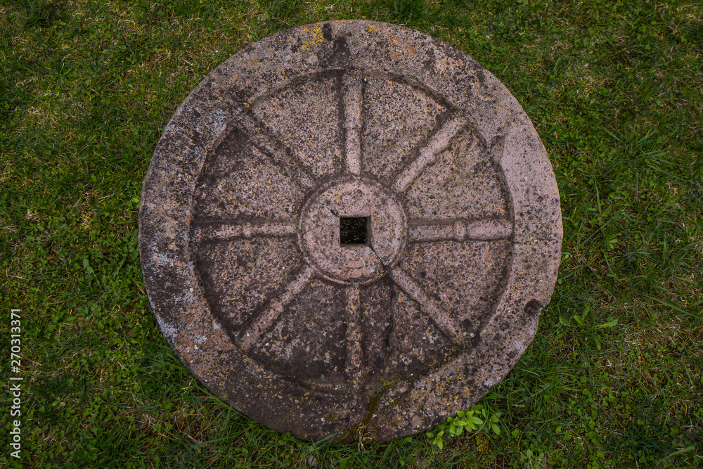 old carved stone wheel