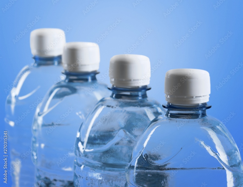 Plastic bottles of water isolated on background