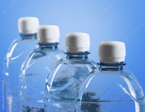 Plastic bottles of water isolated on background