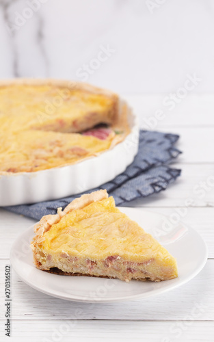 A Slice of Classic Quiche Lorraine on a Wooden Table