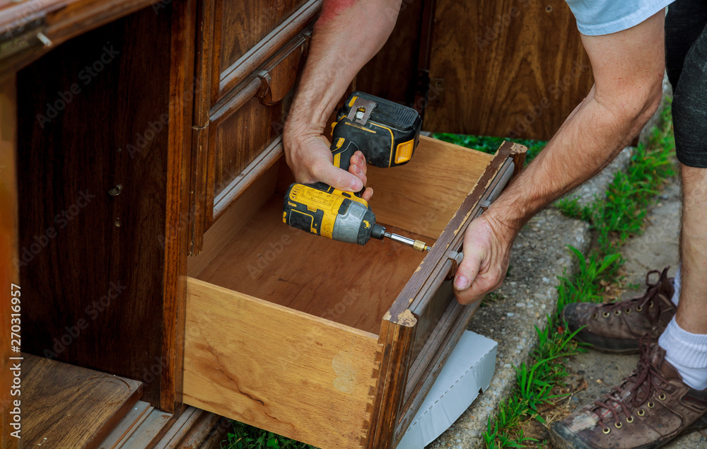 The installing a furniture handle process of assembling cabinet