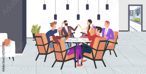 businesspeople group having meeting sitting at round table brainstorming colleagues raising hands successful teamwork concept modern conference room office interior flat full length
