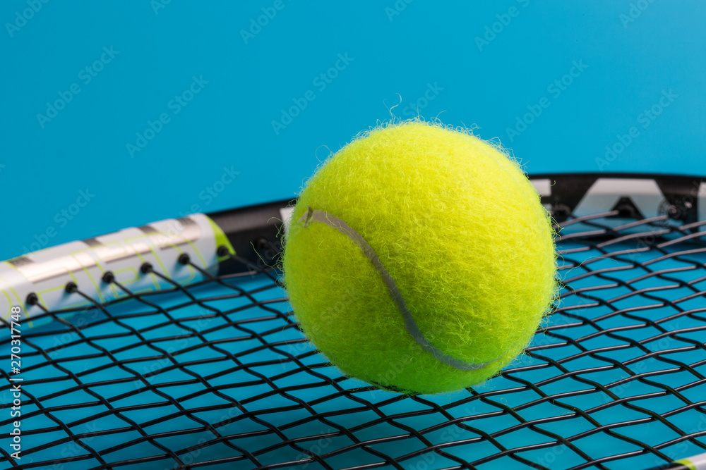 Blue background, yellow green tennis close-up
