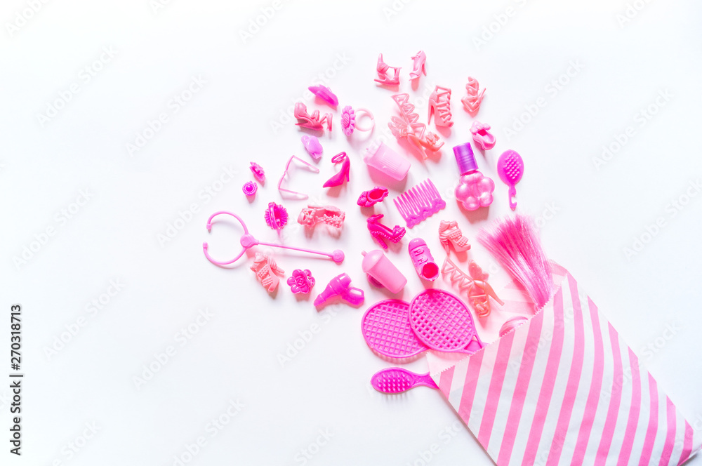 Girly toys for the baby in the pink package. Accessories for dolls. Flat lay. Copy Space Girly toys for the baby in the pink package. Accessories for dolls. Flat lay. Copy Space