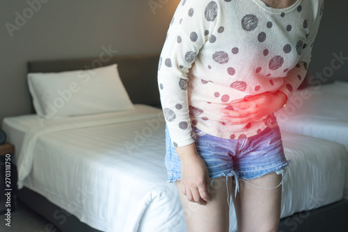 Woman having painful stomachache,Female suffering from abdominal pain,Period cramps or premenstral syndrome at home,Copy space for text photo