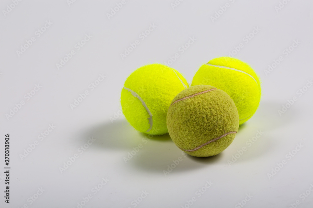 White background, yellow-green tennis ball closeup