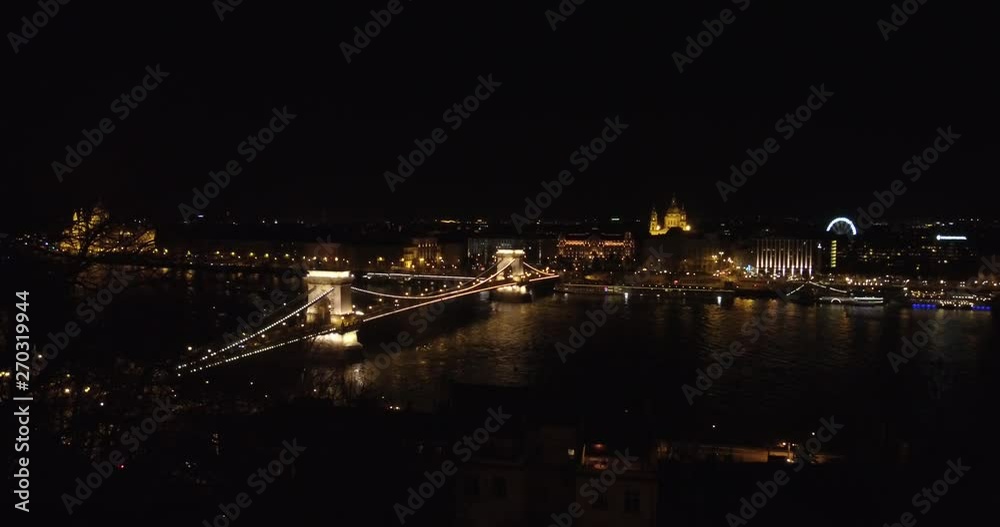 The Chain Bridge, Gresham Palace and St. Stephen's Basilica at night in Budapest. The Chain Bridge, Gresham Palace and St. Stephen's Basilica at night in Budapest.