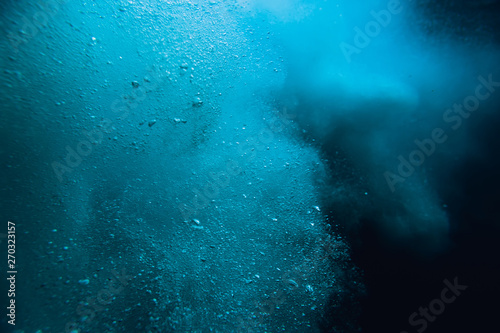 Wave underwater with air bubbles. Blue crystal ocean in underwater © artifirsov