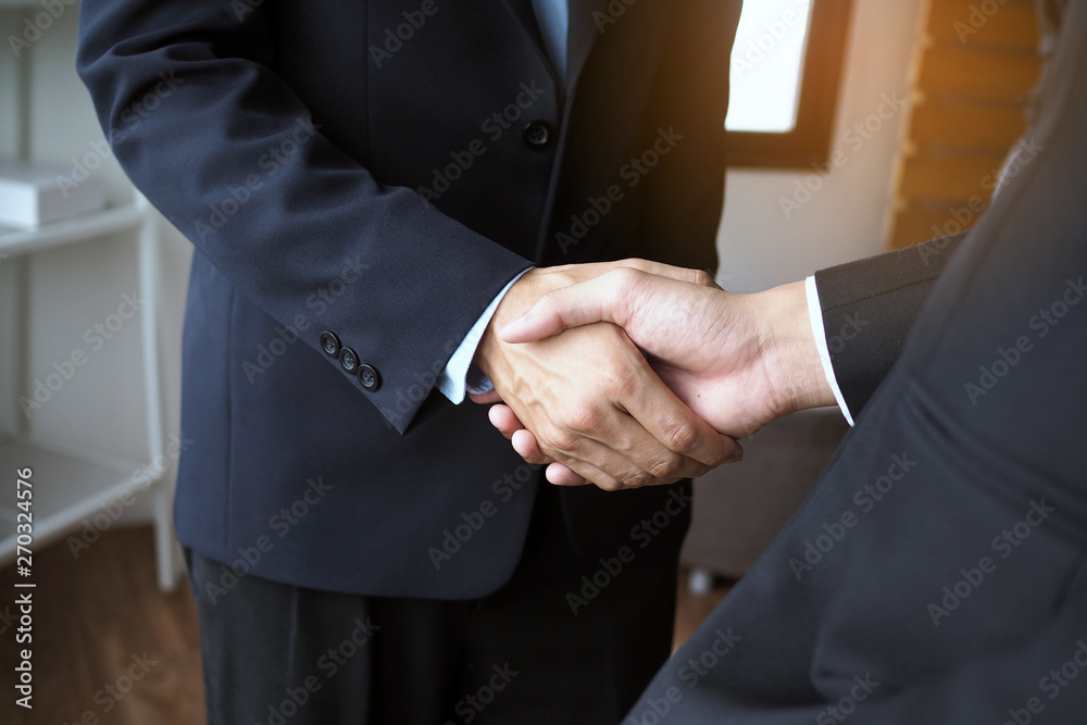 Two executives handshake as partners after the successful meeting.