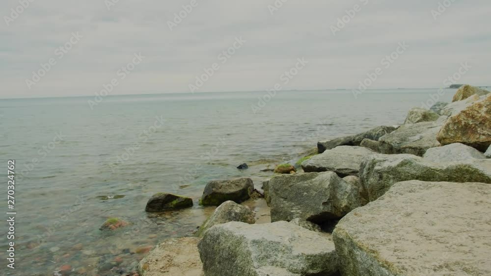 A beautiful view by the sea. Sandy beach, sea waves and sky. Slowmotion A beautiful view by the sea. Sandy beach, sea waves and sky. Slowmotion
