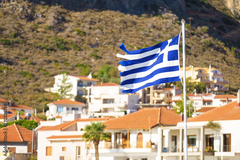 Fototapeta premium Greek flag against town